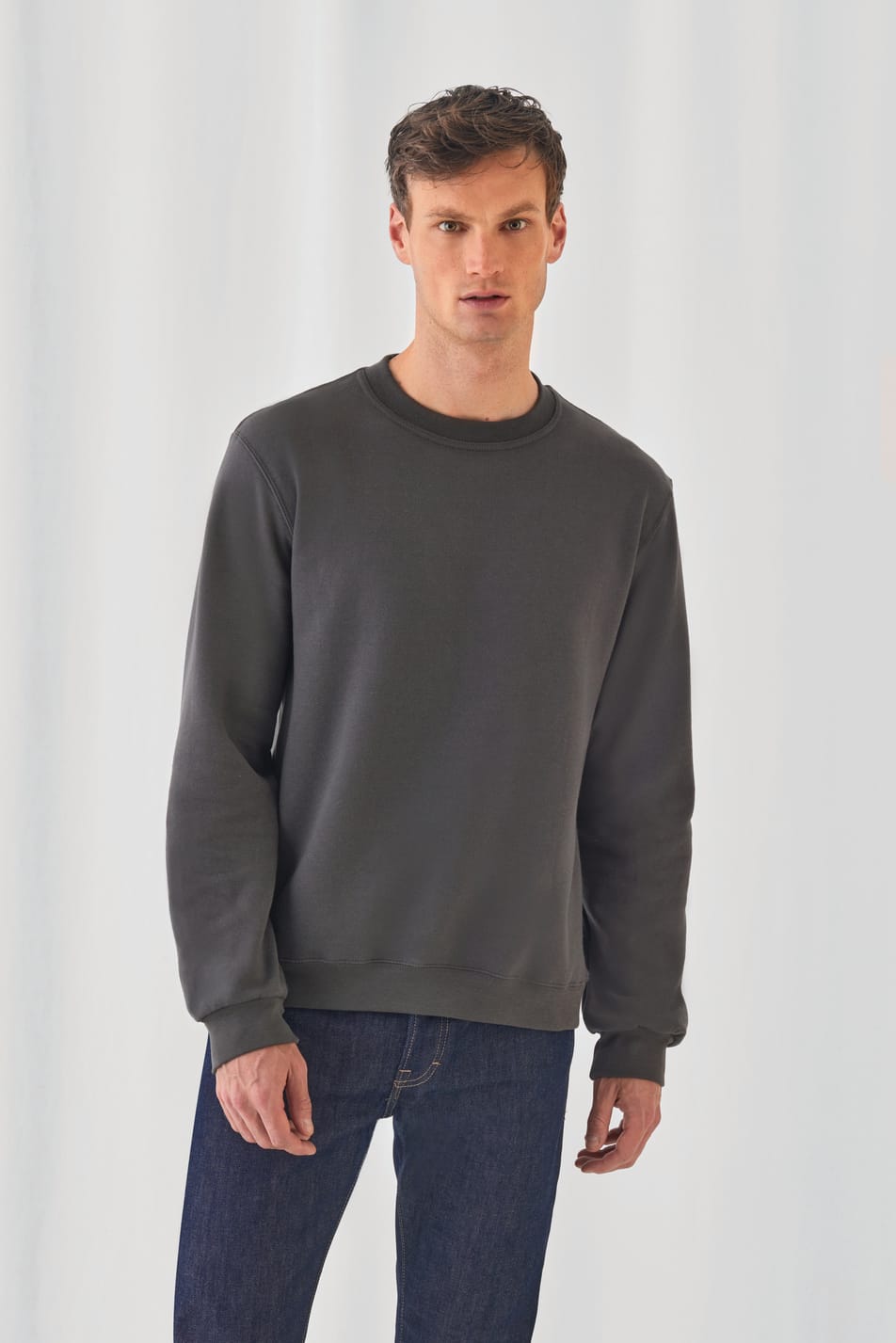 sweat-shirt gris foncé col rond coupe classique avec col poignet et bas en bord-côte porté par un homme