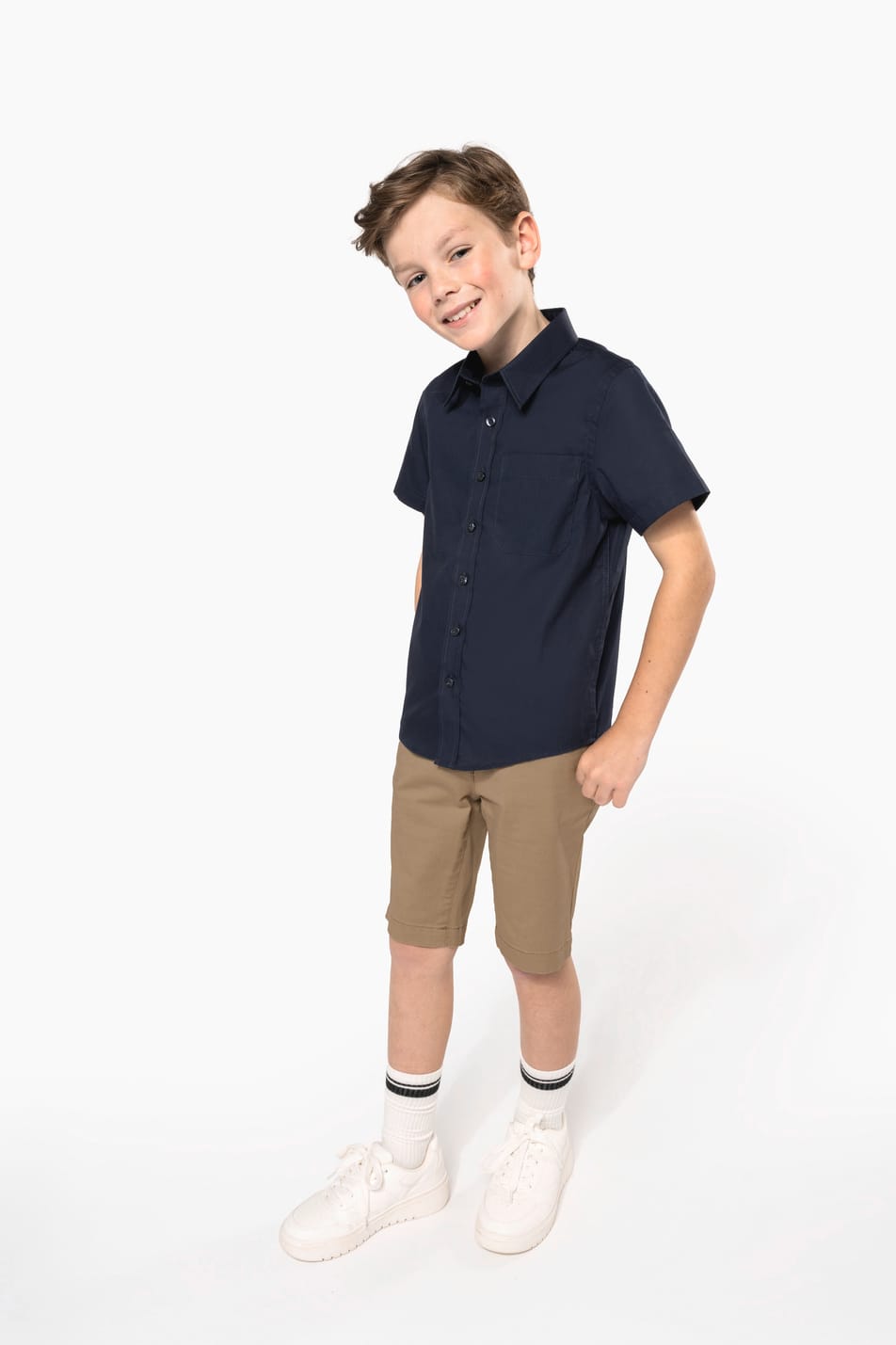 Jeune garçon cheveux courts châtain qui porte une chemise popeline manches courtes Navy.