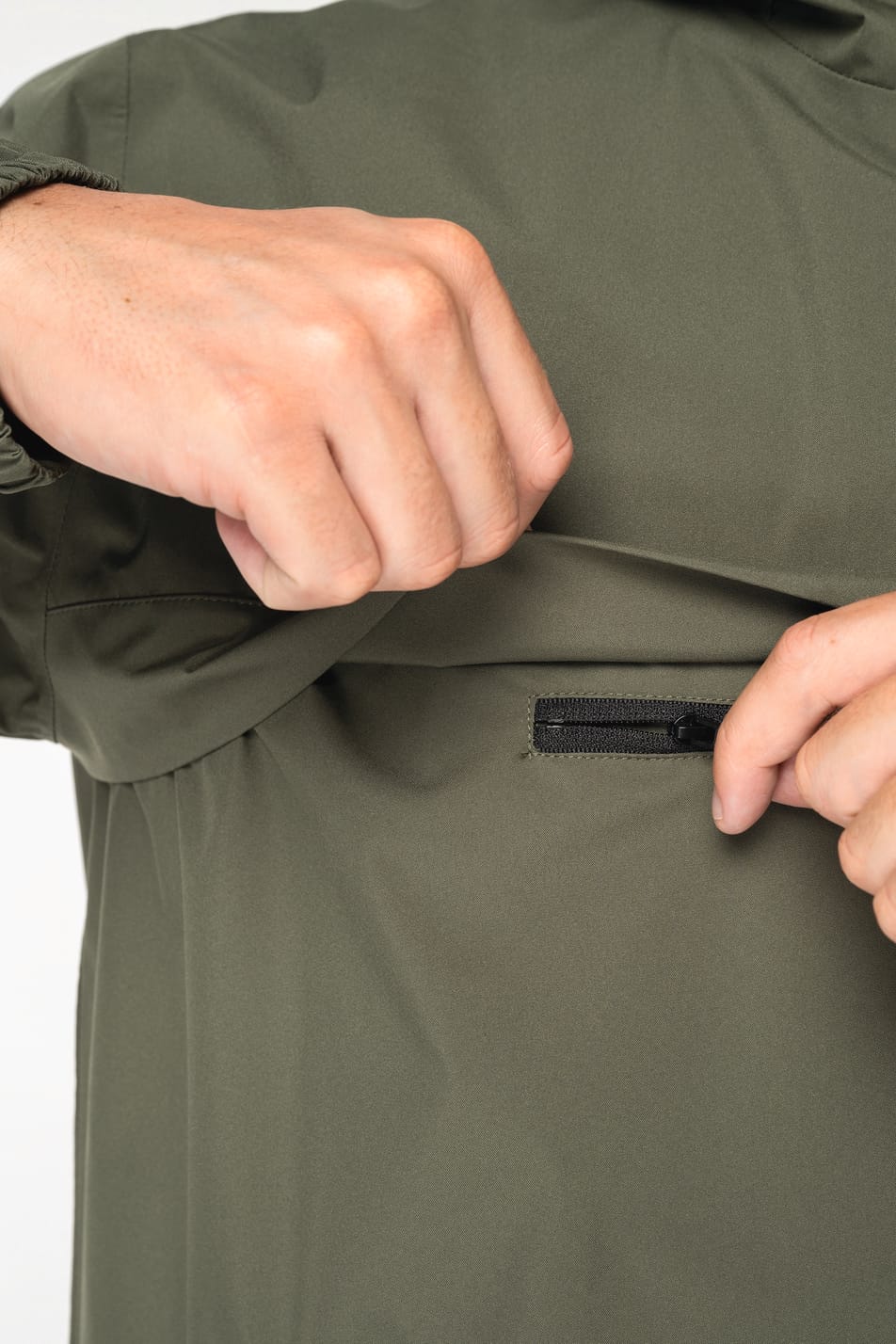 Détail d'une veste coupe-vent quart zip kaki portée par un homme