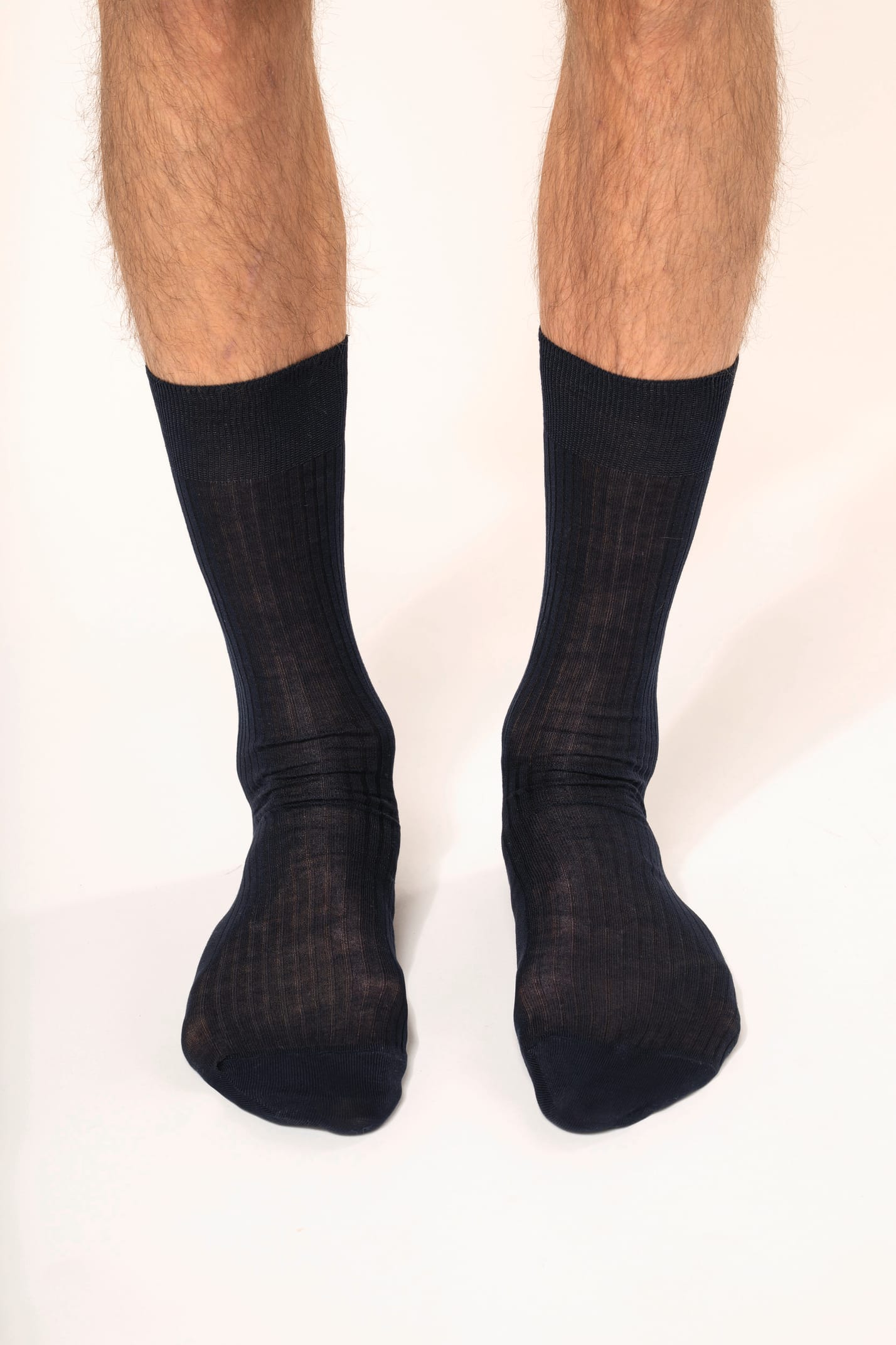 Homme qui porte une paire de chaussettes coton rib 4x2 fil d'Écosse coloris bleu marine.
