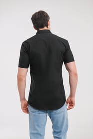 chemise noire manches courtes coupe ajustée portée par un homme vu de dos