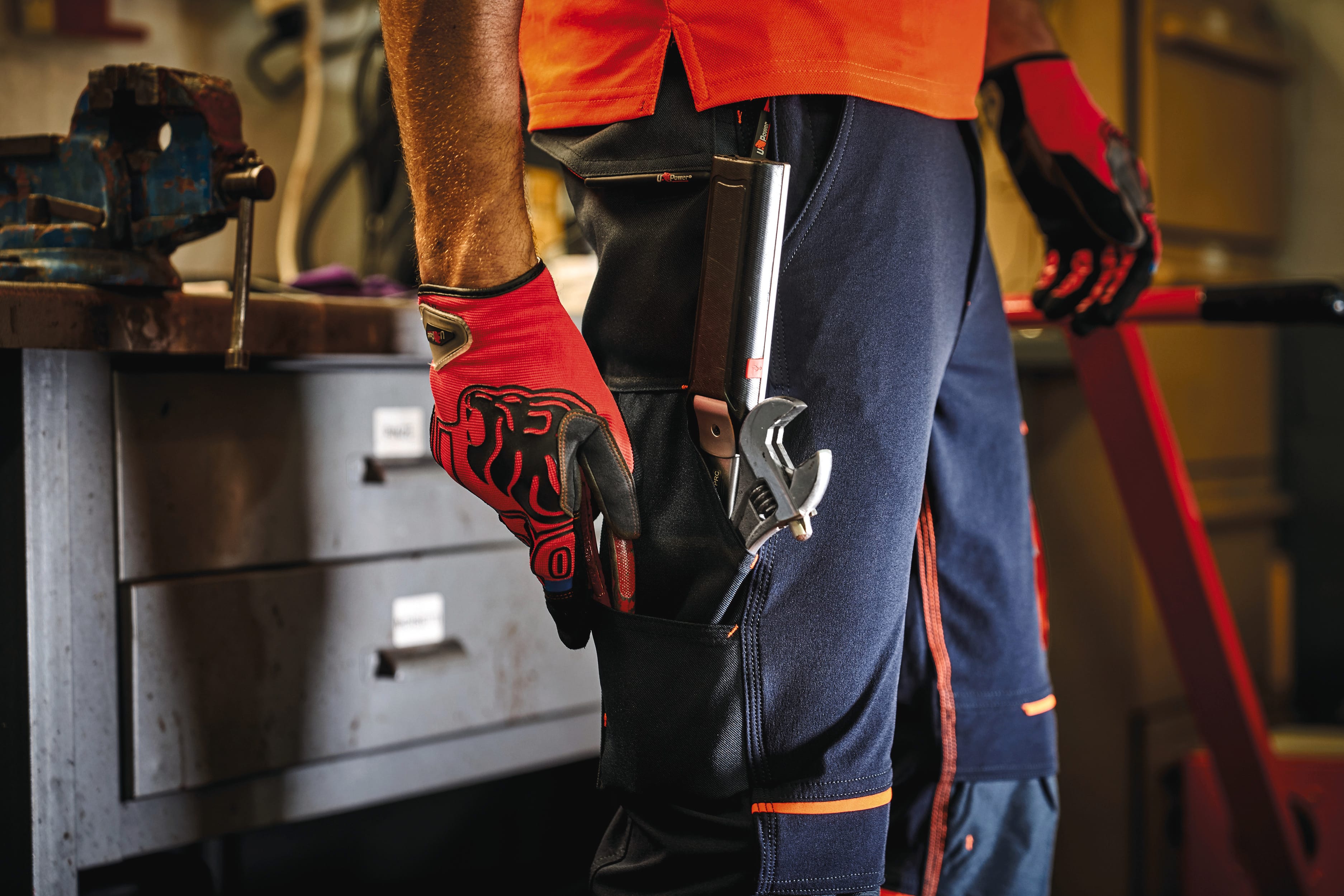détail poche latérale sur pantalon bleu foncé avec détails orange 